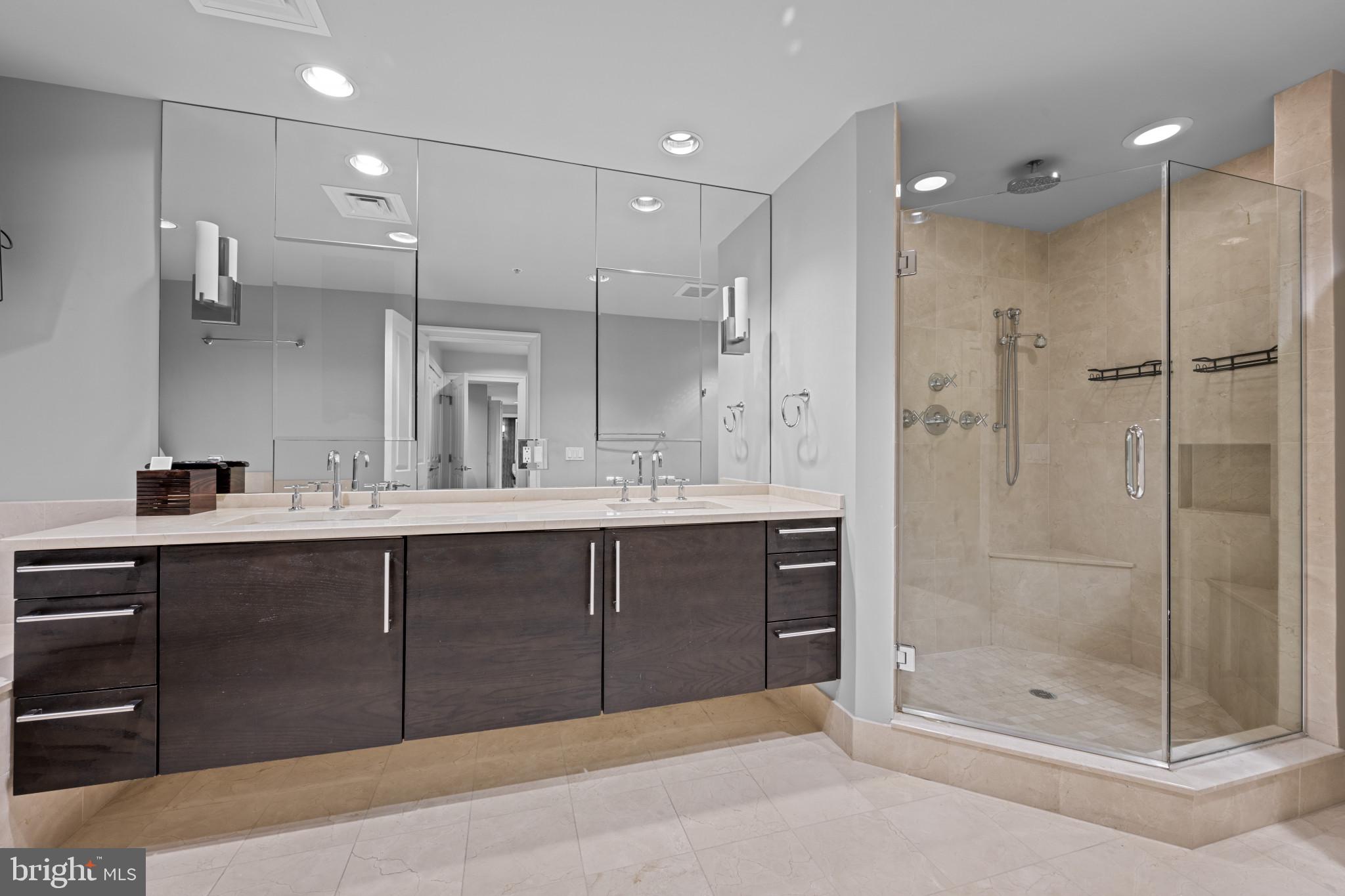 801 Key Highway, Unit 458 Baltimore, MD 21230 - Photo 24 of 48 a bathroom with a shower sink and mirror