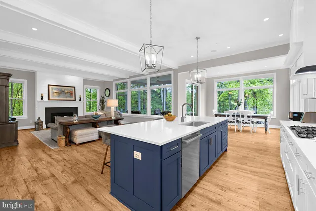 a large kitchen with kitchen island a large counter space windows and stainless steel appliances