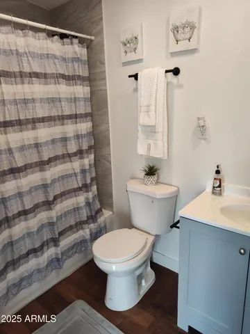 a white toilet sitting next to a bathroom sink
