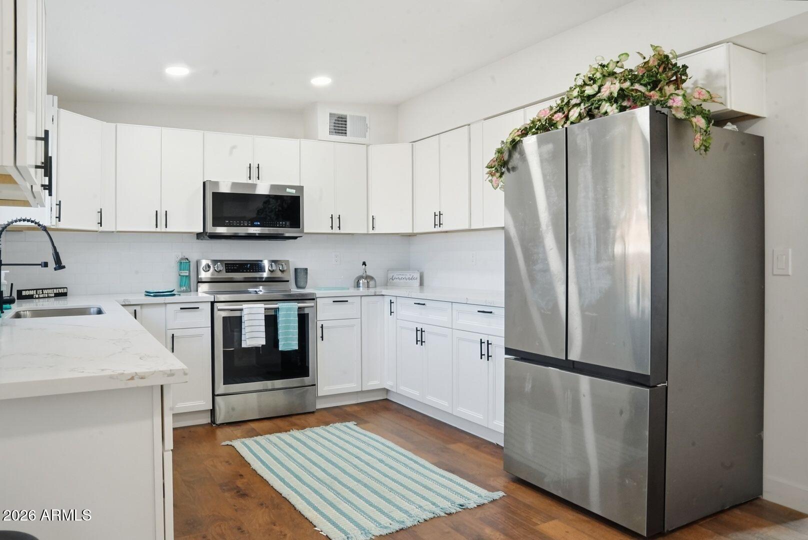 408 Hartford Road Kearny, AZ 85137 - Photo 10 of 27 a kitchen with stainless steel appliances a refrigerator stove and sink