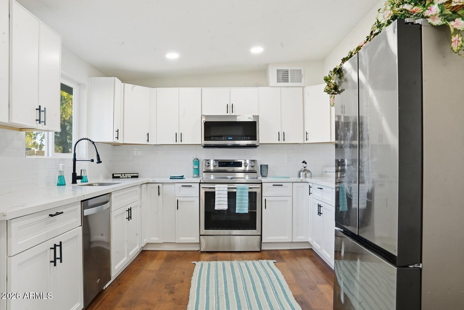 408 Hartford Road Kearny, AZ 85137 - Photo 11 of 27 a kitchen with stainless steel appliances a refrigerator sink and microwave