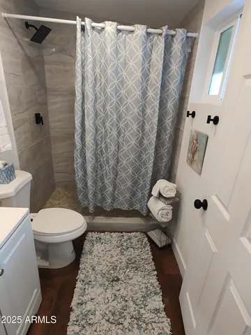 a bathroom with a toilet and a shower