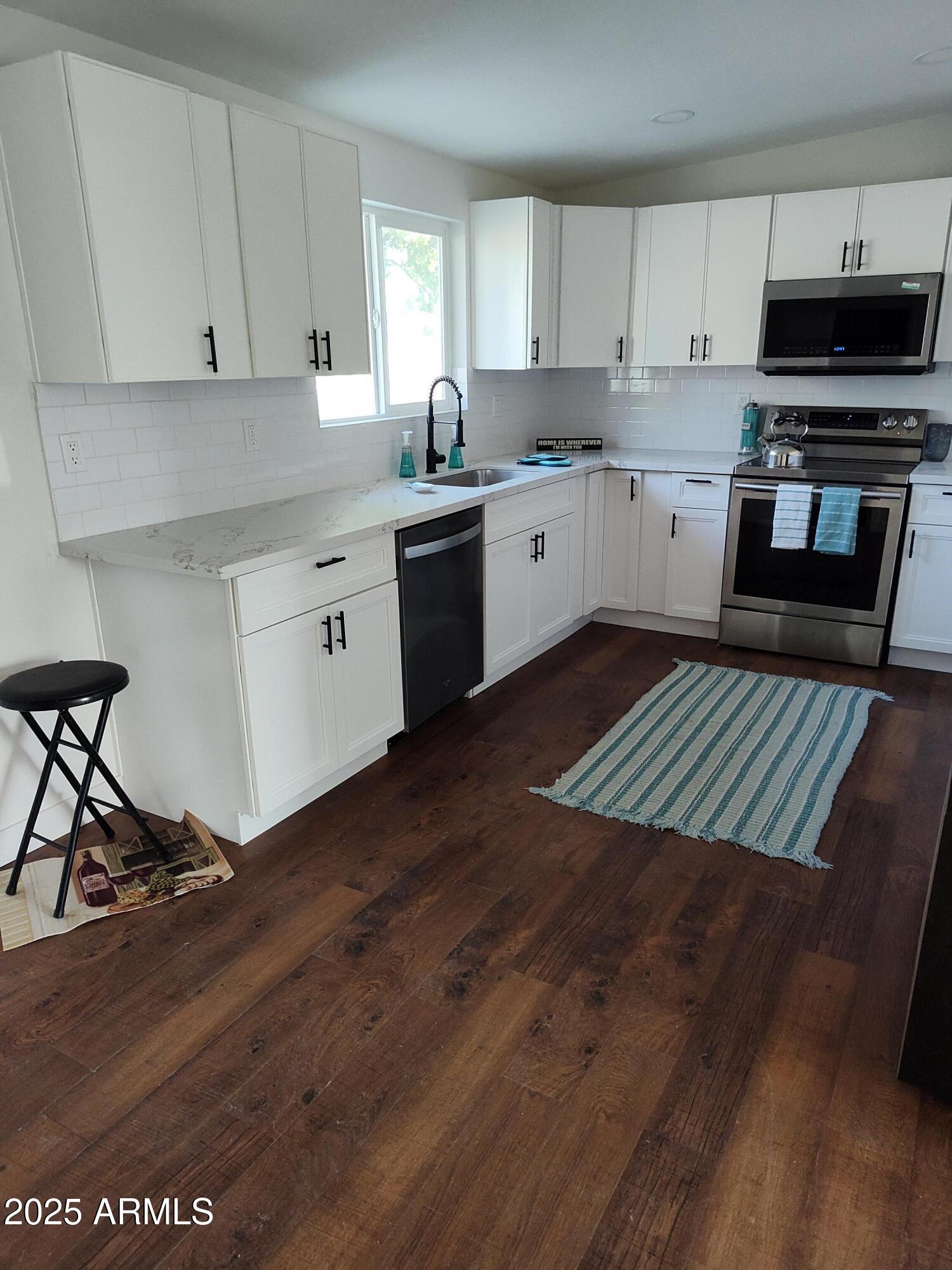 408 Hartford Road Kearny, AZ 85137 - Photo 6 of 20 a kitchen with a sink a stove and cabinets