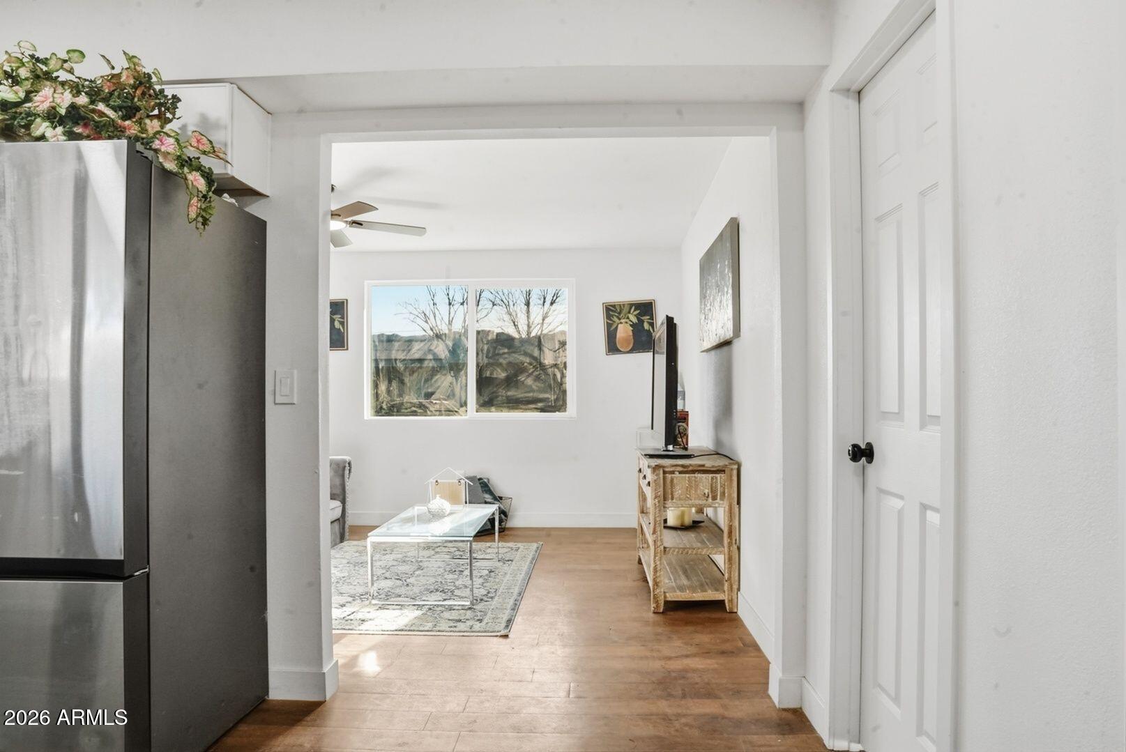 408 Hartford Road Kearny, AZ 85137 - Photo 8 of 27 a view of a hallway with wooden floor and a livingroom with furniture