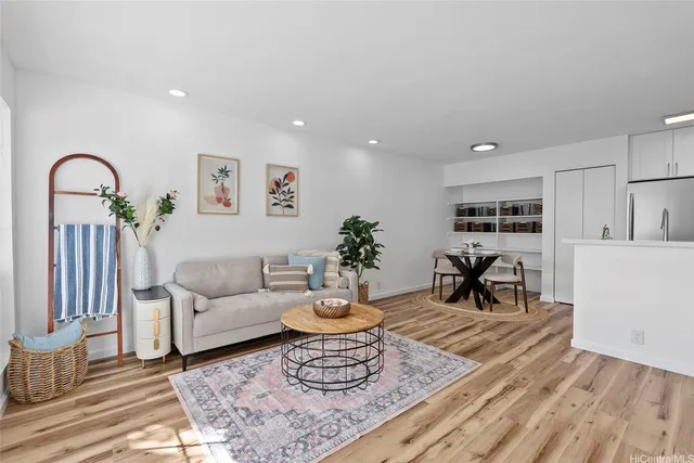 a living room with furniture and wooden floor
