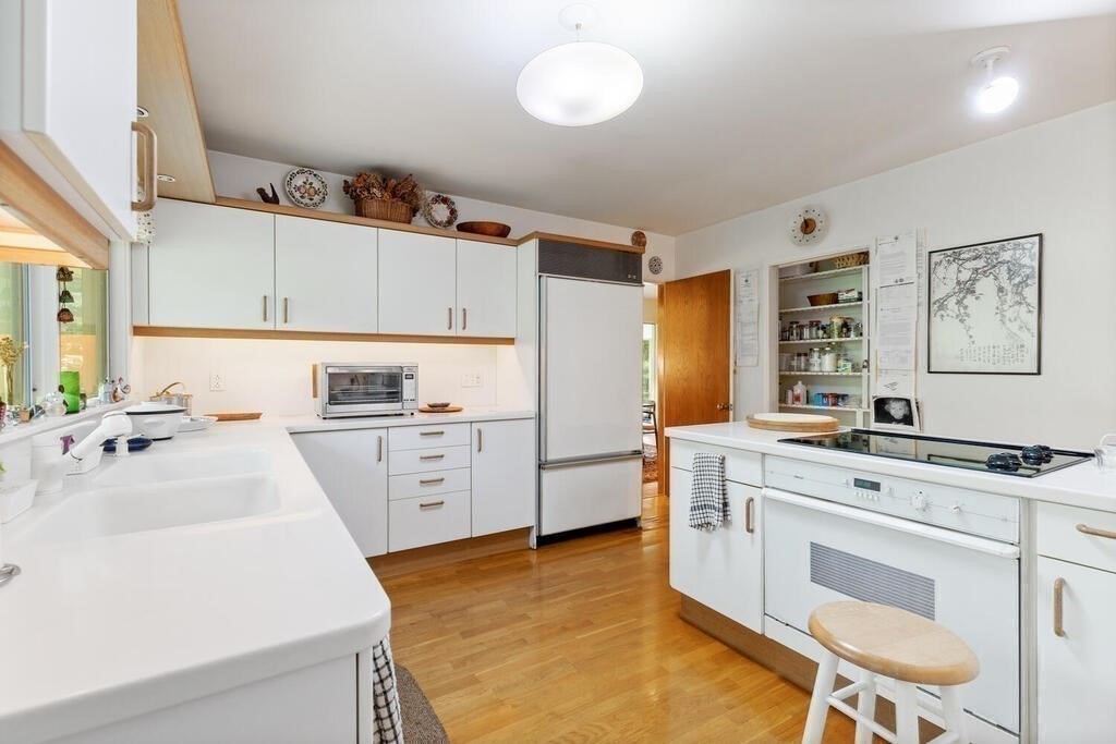 7 Leeland Terrace Lexington, MA 02421 - Photo 12 of 32 a kitchen with a stove a sink and a refrigerator