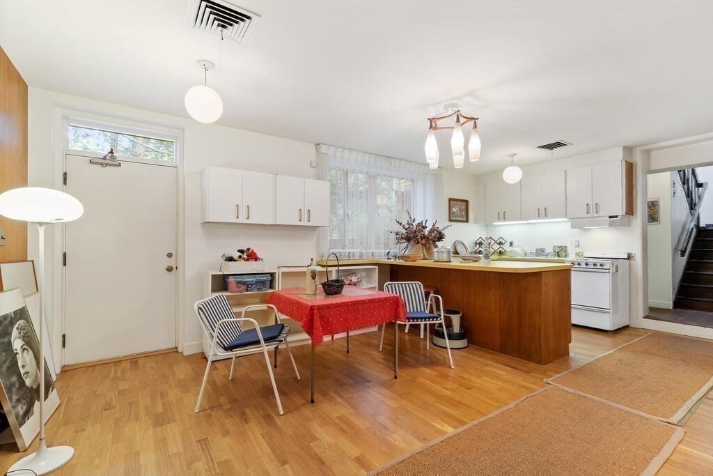 7 Leeland Terrace Lexington, MA 02421 - Photo 24 of 32 a kitchen with a table chairs and a refrigerator