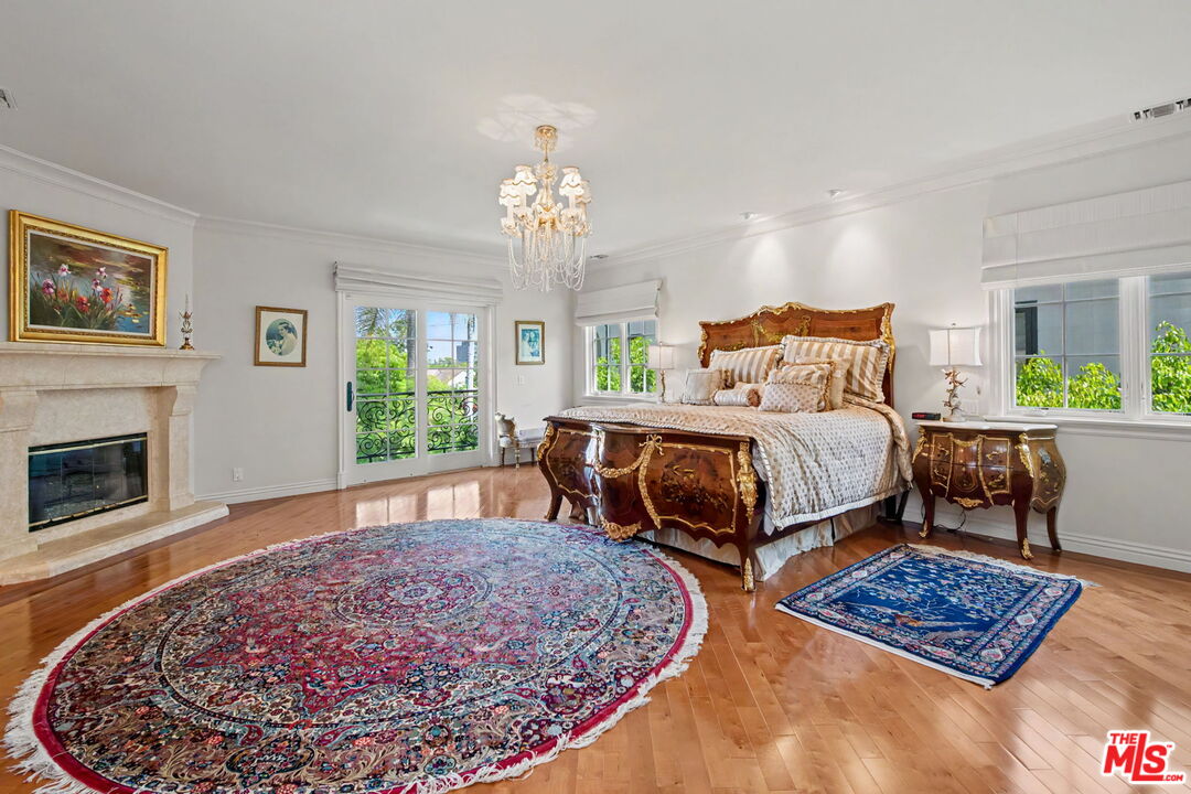 204 Foothill Road Beverly Hills, CA 90210 - Photo 26 of 38 a bedroom with bed and a fireplace