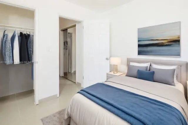 a bedroom with a bed and a view of bathroom