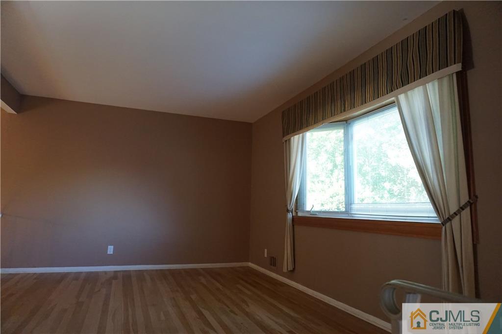 22 Magee Road Edison, NJ 08817 - Photo 3 of 20 a view of an empty room with wooden floor and a window