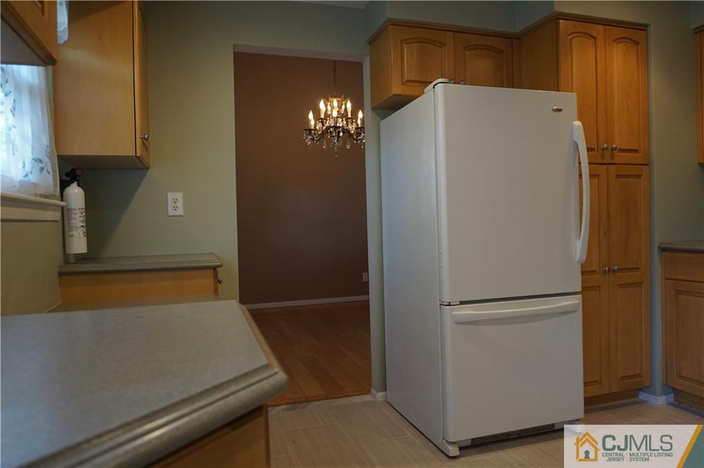 22 Magee Road Edison, NJ 08817 - Photo 8 of 20 a white refrigerator freezer and a stove sitting inside of a kitchen