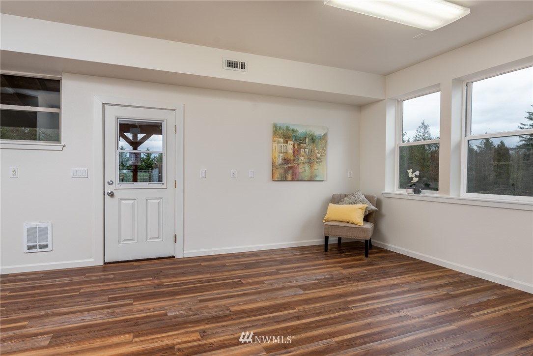 672 East Smith Road Bellingham, WA 98226 - Photo 5 of 25 a room with a wooden floor and a window