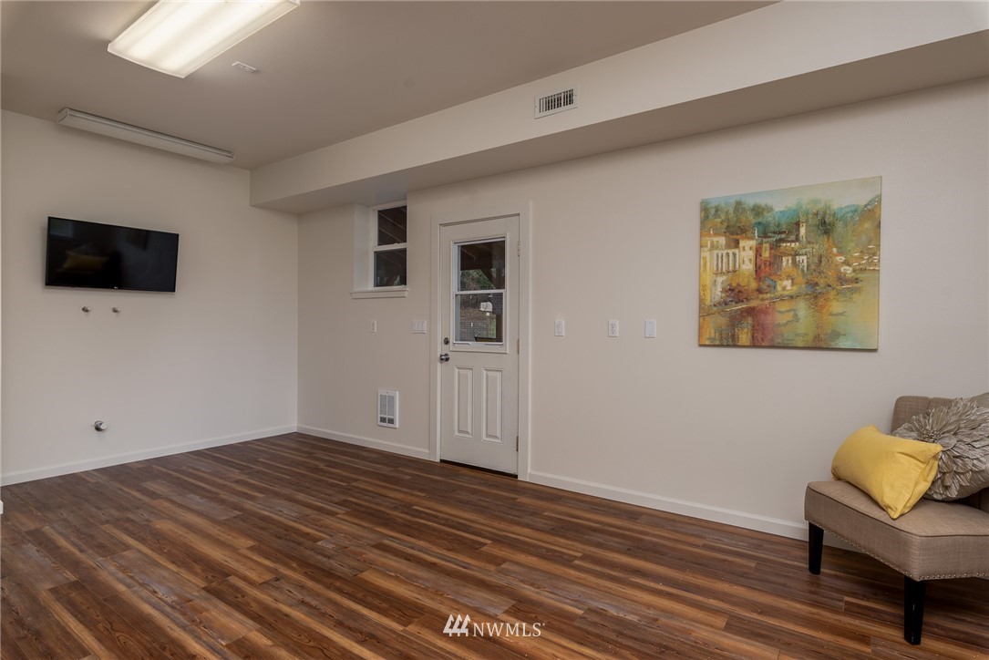 672 East Smith Road Bellingham, WA 98226 - Photo 6 of 25 a view of room with hardwood floor and lounge chair