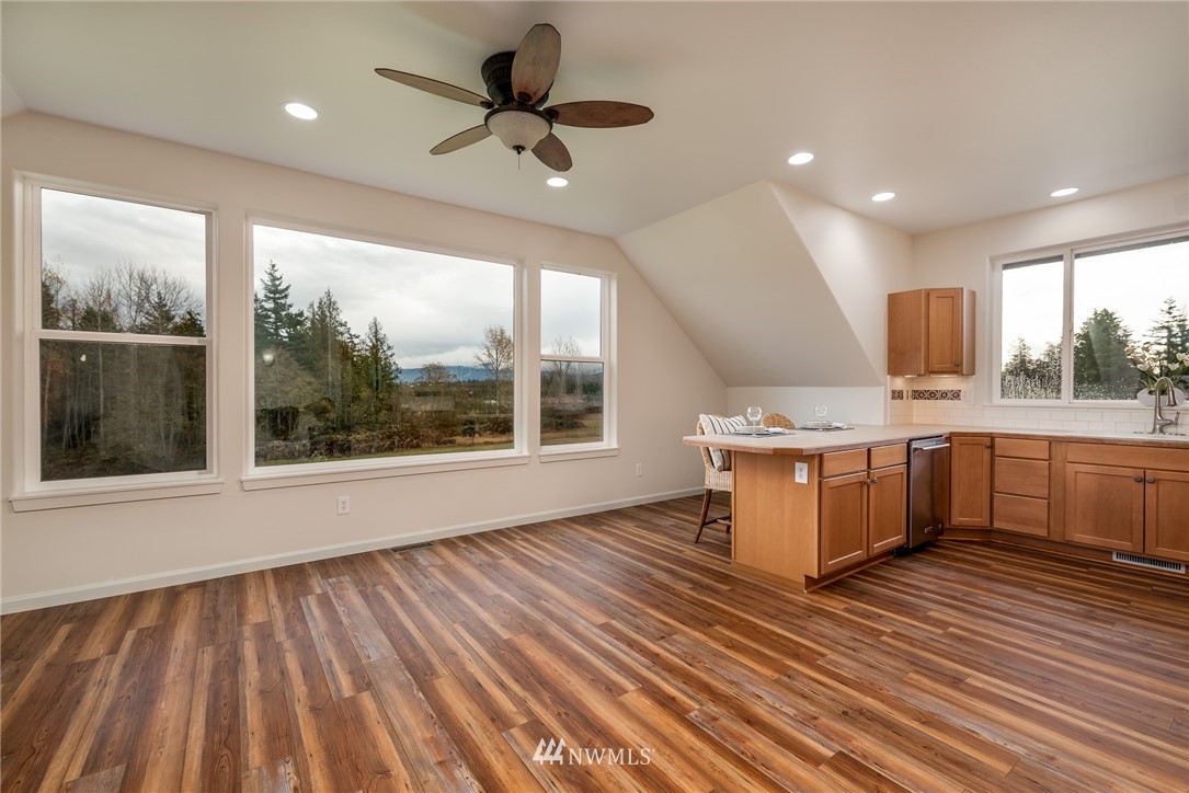 672 East Smith Road Bellingham, WA 98226 - Photo 8 of 25 a kitchen with stainless steel appliances granite countertop a sink a stove top oven a counter space and cabinets