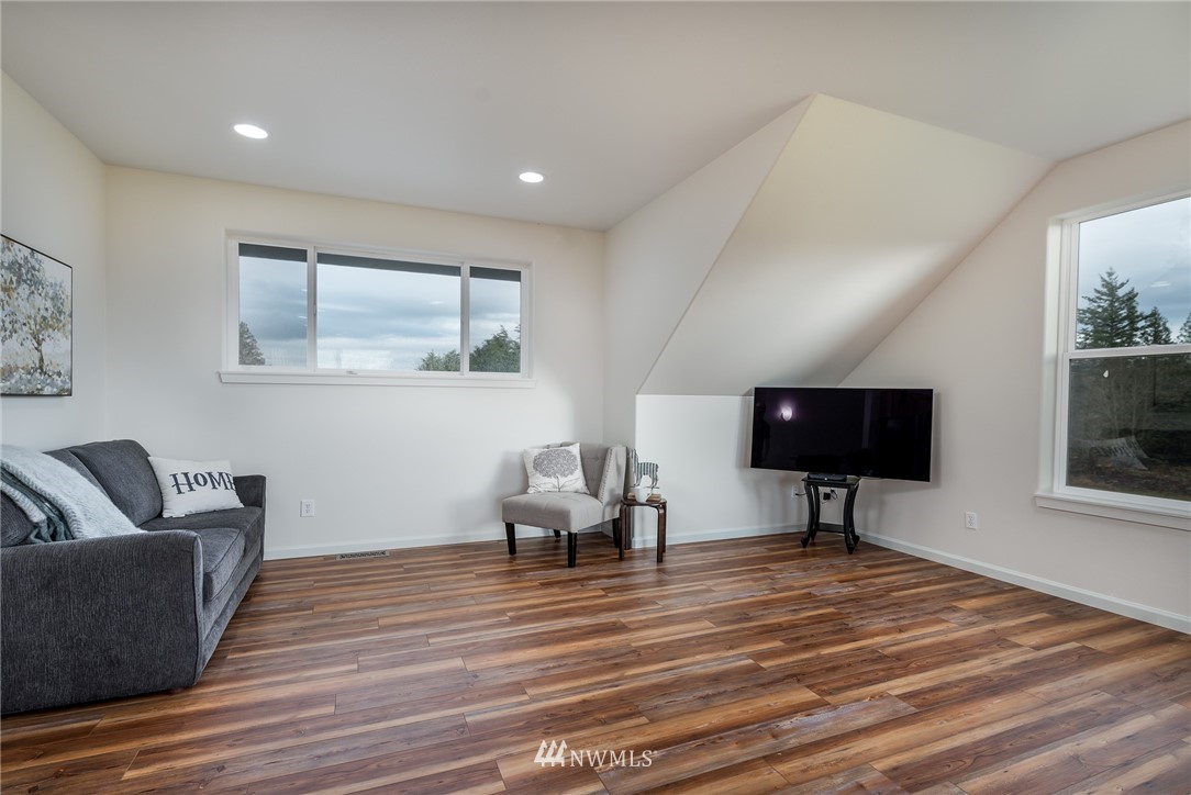 672 East Smith Road Bellingham, WA 98226 - Photo 10 of 25 a living room with furniture and a flat screen tv