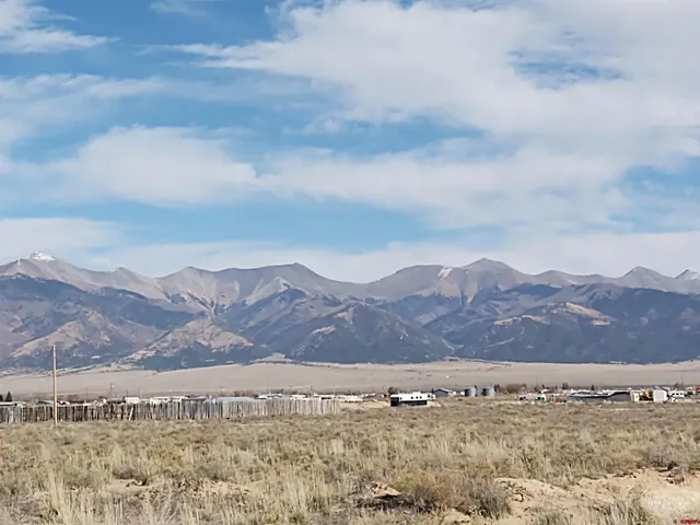front view of a large mountain with mountains in the background