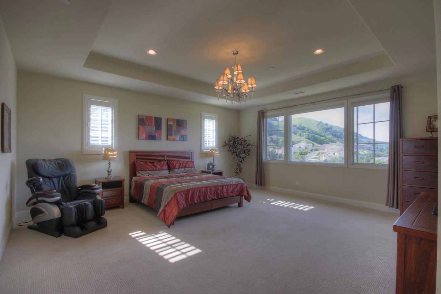 3242 Ashbourne Circle San Ramon, CA 94583 - Photo 8 of 25 a spacious bedroom with a bed and a chandelier