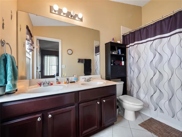 a bathroom with a sink vanity mirror and toilet