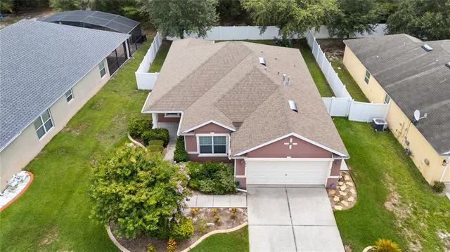 an aerial view of a house with a yard