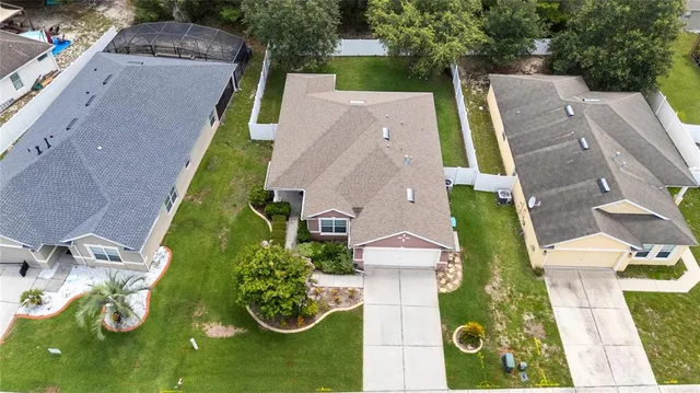 an aerial view of a house with outdoor space
