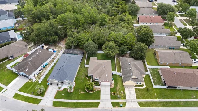 an aerial view of residential houses with outdoor space and street view