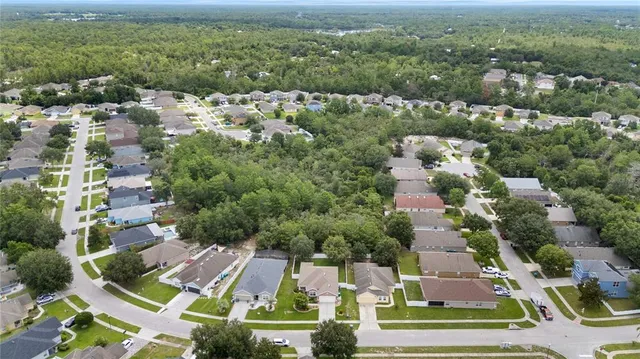 an aerial view of residential houses with outdoor space and river