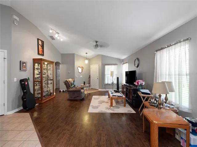 a living room with fireplace furniture and a flat screen tv