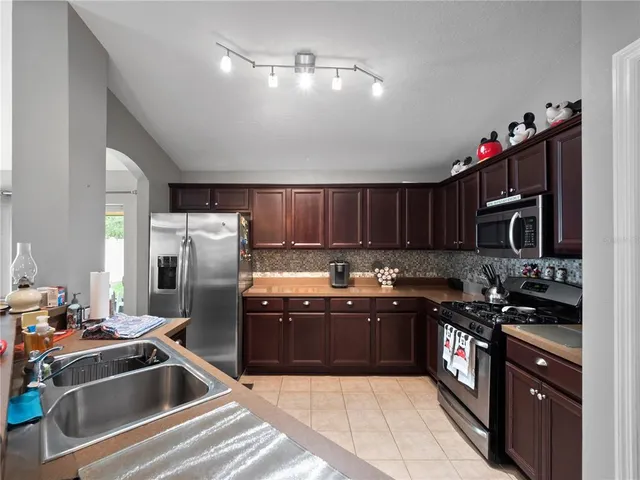 a kitchen with sink cabinets and stainless steel appliances