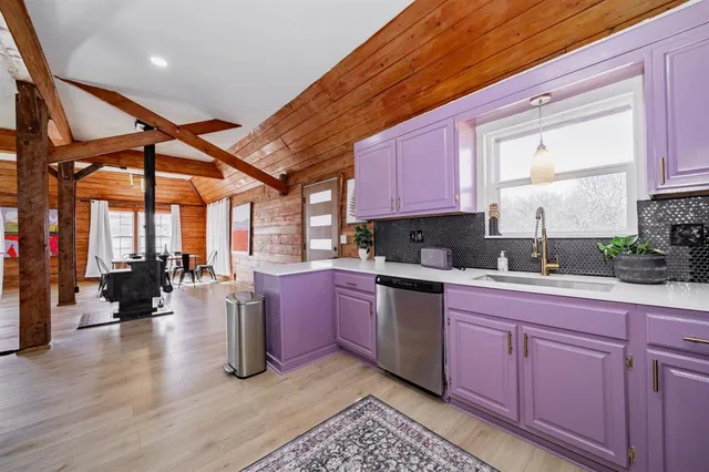 a view of a hallway to a house and wooden floor
