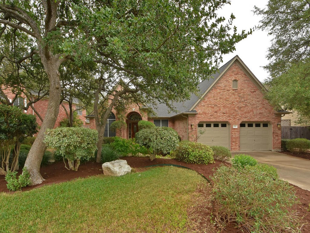 5441 Austral Loop Austin, TX 78739 - Photo 1 of 1 a front view of a house with a yard and garage