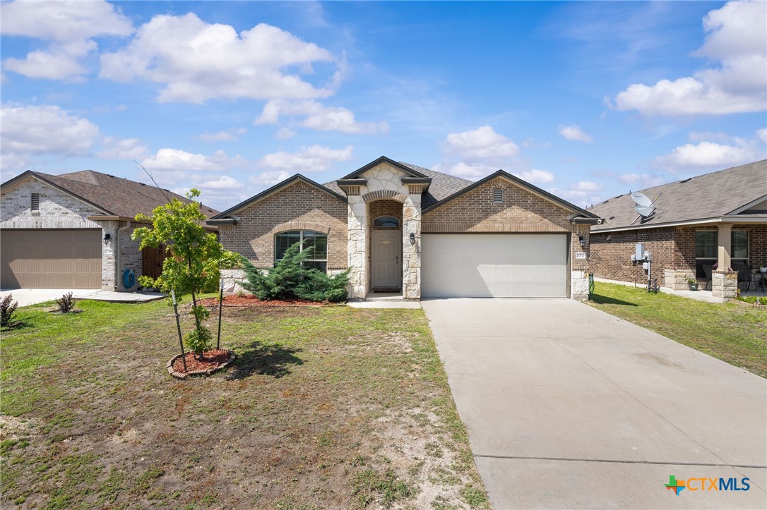 a front view of a house with a yard and garage
