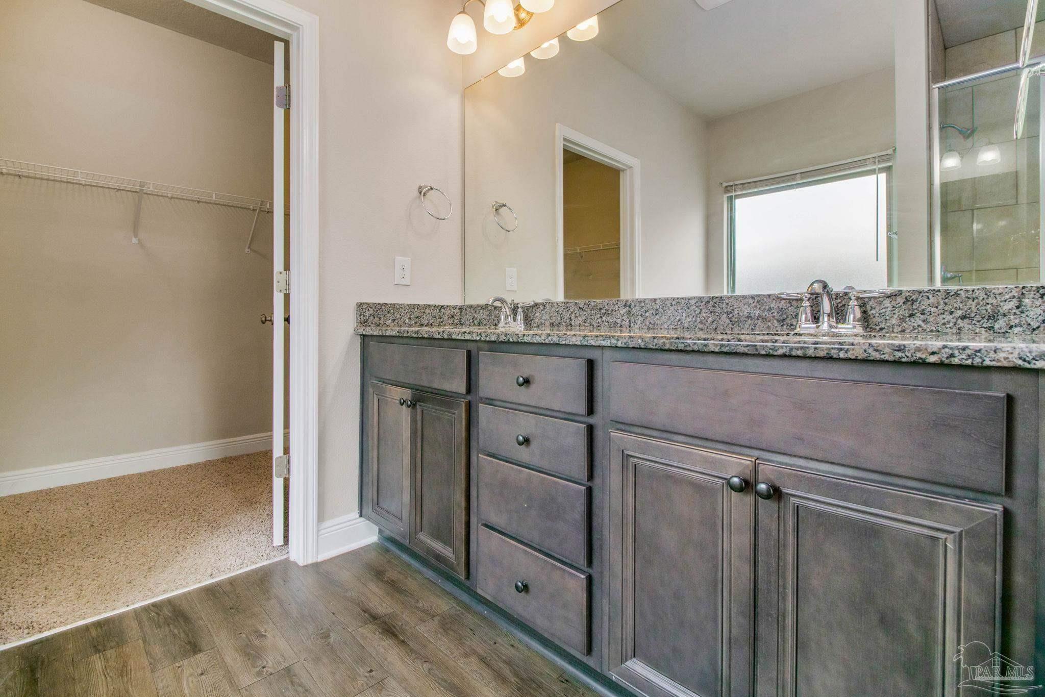 6348 Ladera Trail Pace, FL 32571 - Photo 23 of 50 a bathroom with a granite countertop sink a mirror and a