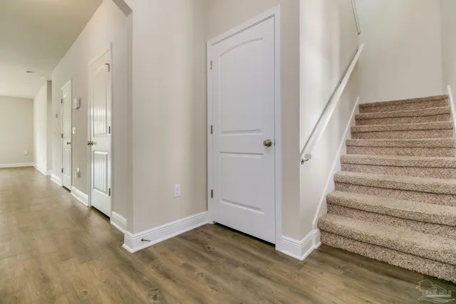 a view of an entryway with wooden floor