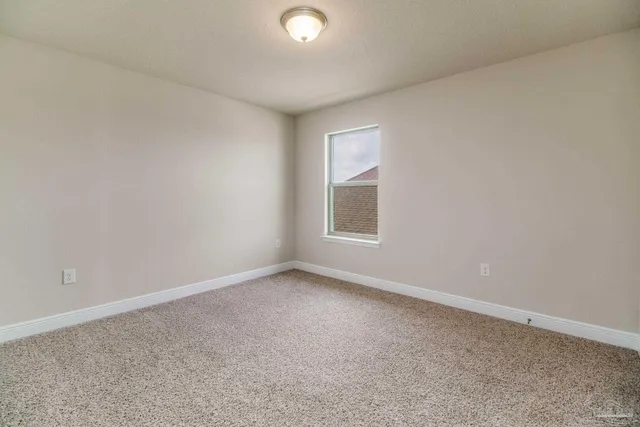 a bathroom with a granite countertop toilet sink and mirror