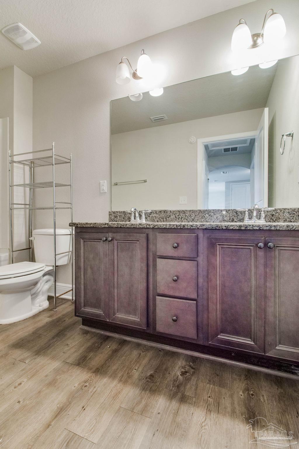 6348 Ladera Trail Pace, FL 32571 - Photo 40 of 50 a bathroom with a granite countertop sink and a mirror
