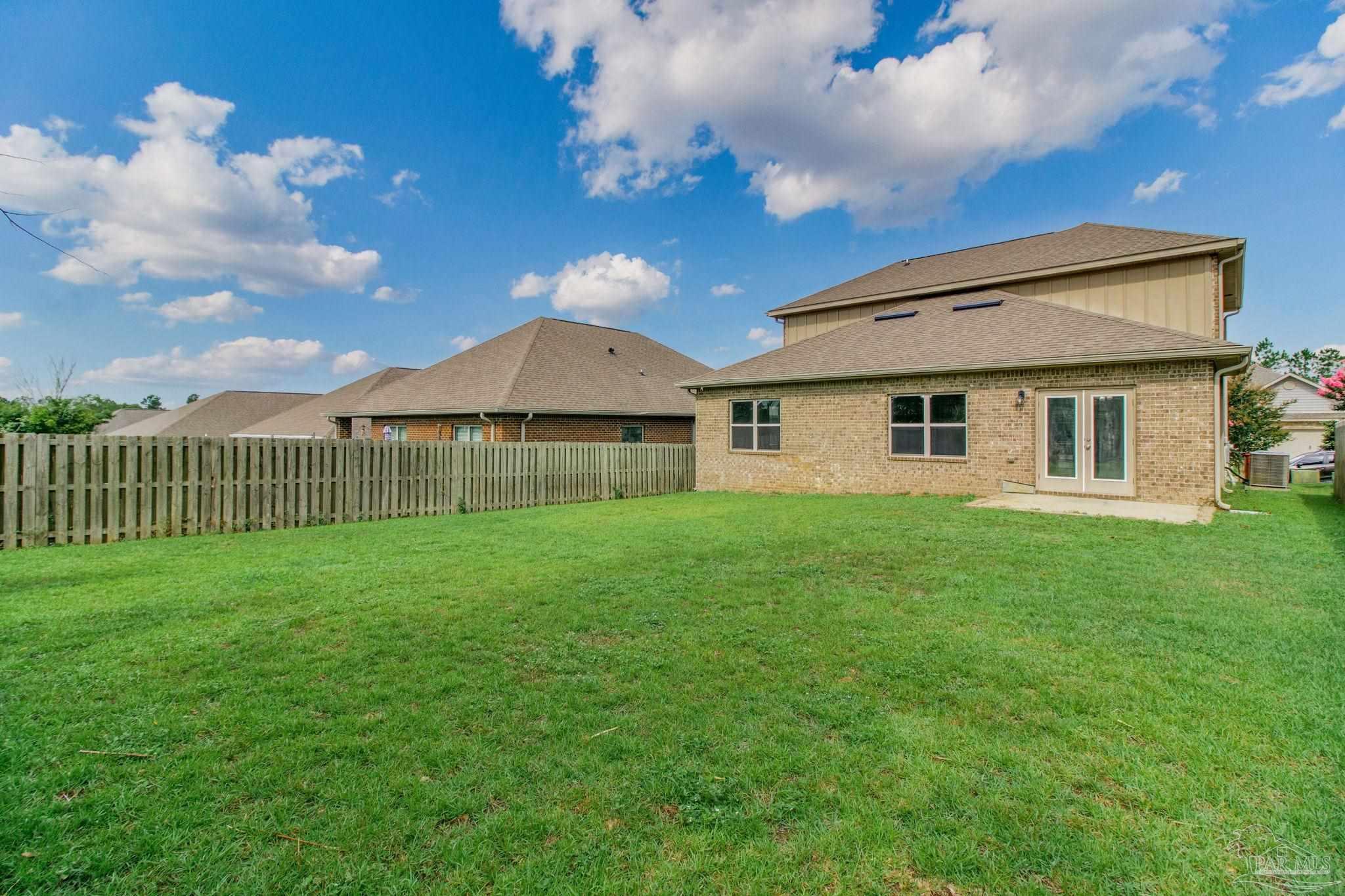 6348 Ladera Trail Pace, FL 32571 - Photo 48 of 50 a view of a house with backyard and garden