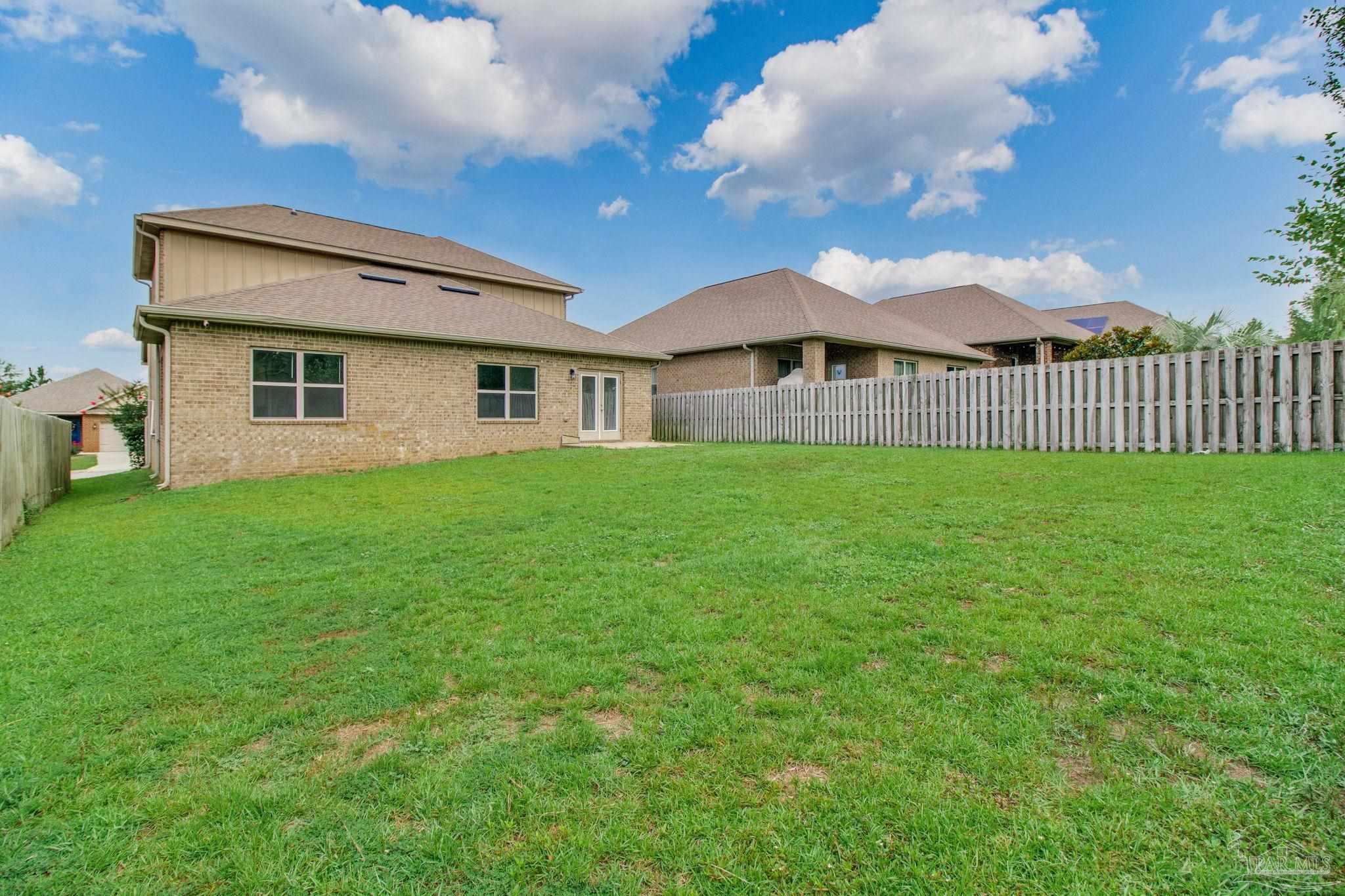 6348 Ladera Trail Pace, FL 32571 - Photo 49 of 50 a view of a house with a yard and a garden