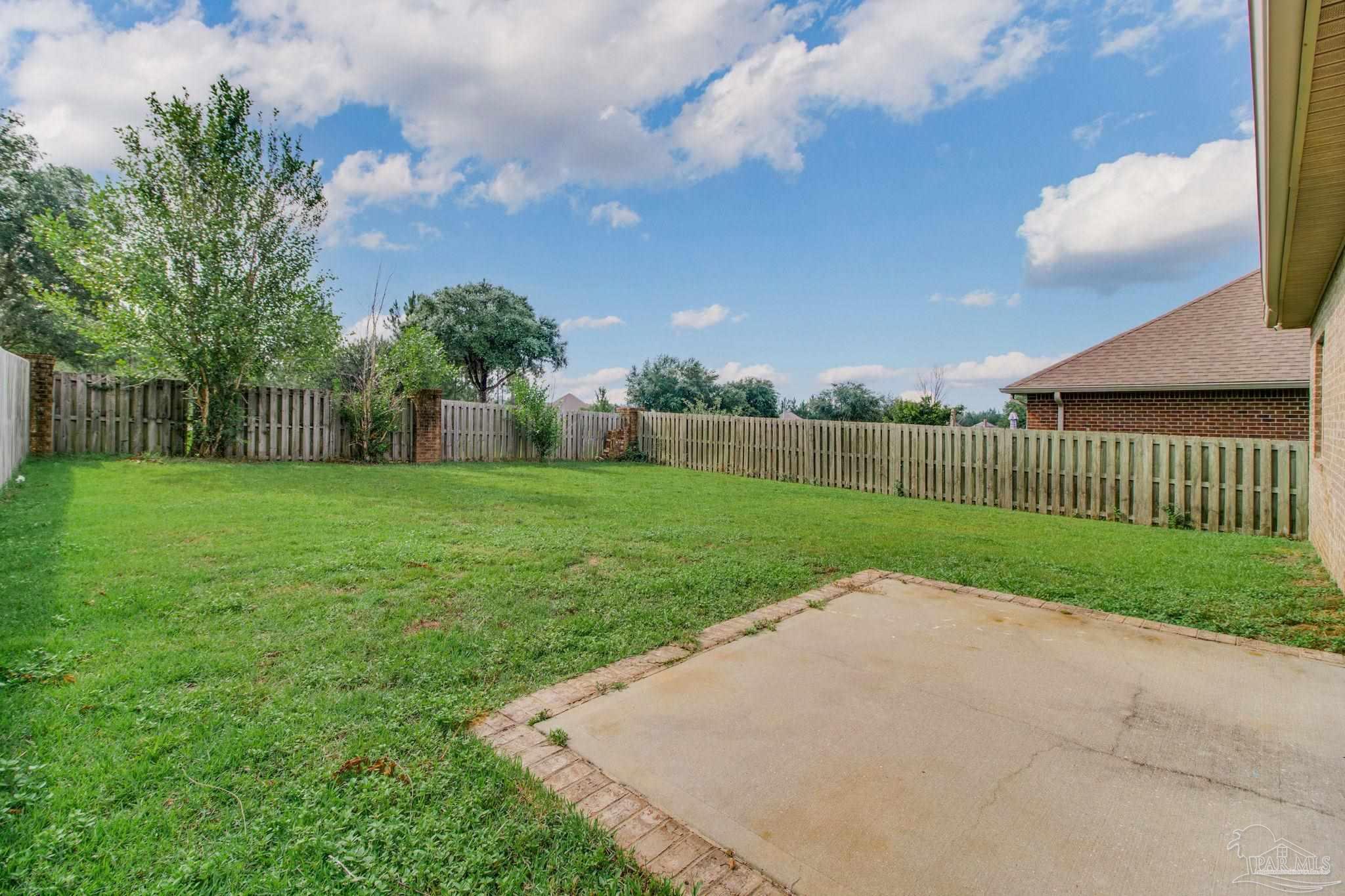 6348 Ladera Trail Pace, FL 32571 - Photo 50 of 50 a view of a backyard with a garden