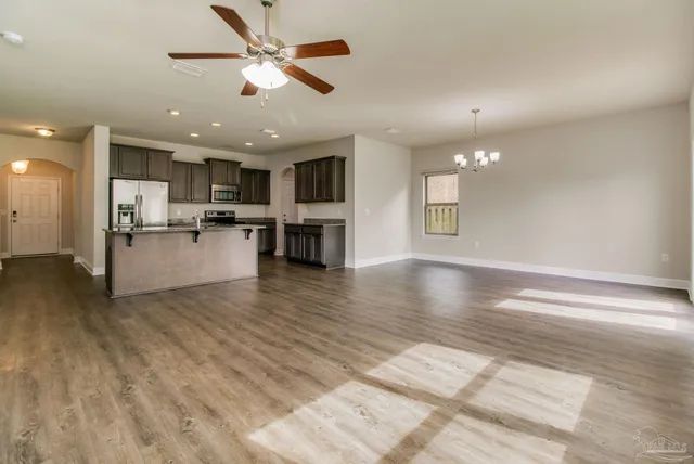 a view of a kitchen and dining room with wooden floor