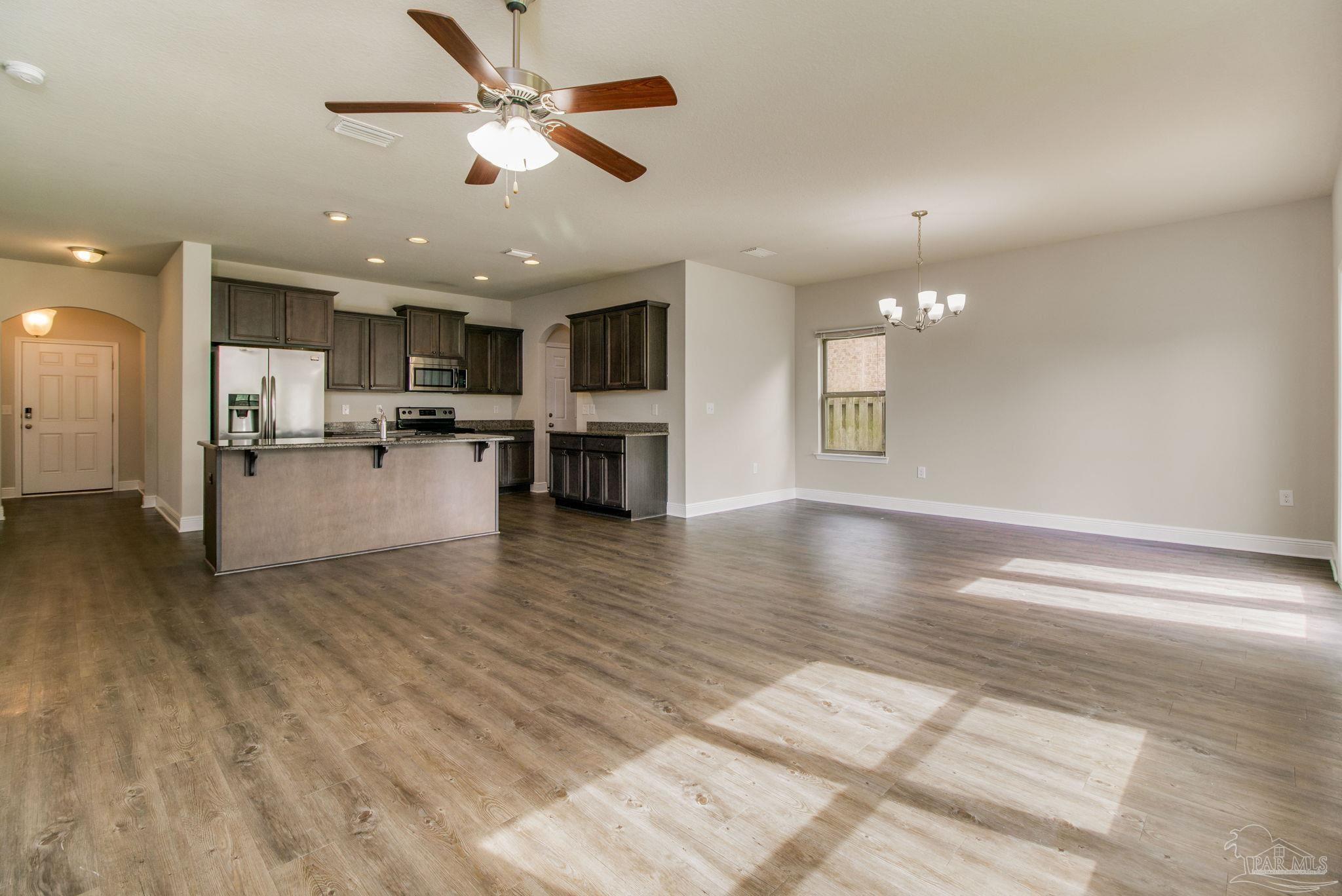 6348 Ladera Trail Pace, FL 32571 - Photo 6 of 50 a view of a kitchen and dining room with wooden floor