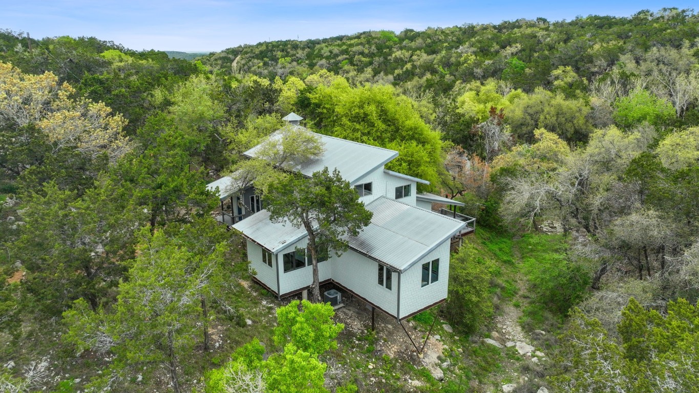 An aerial view of the main home with the creek below