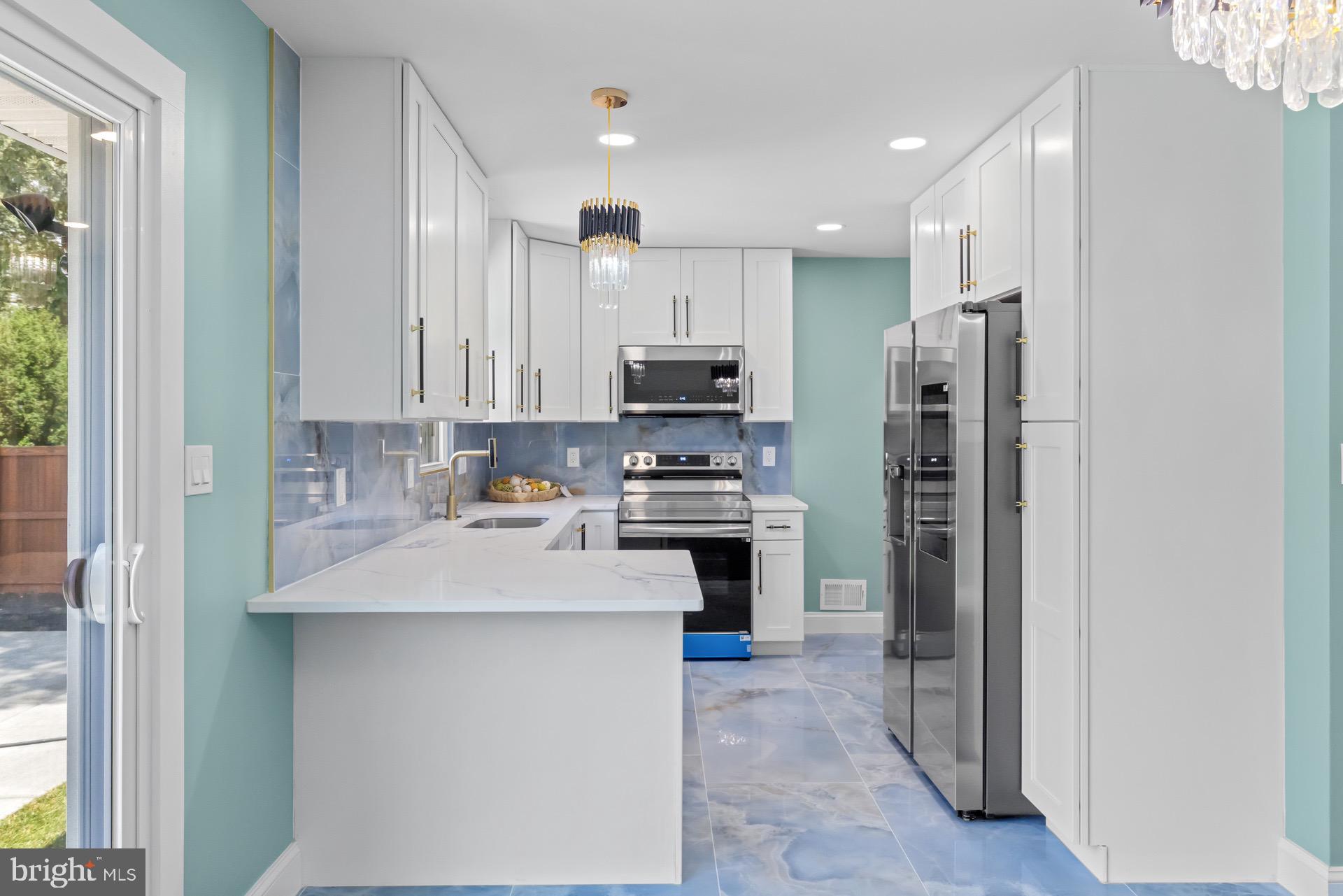 523 Sunset Knoll Road Pasadena, MD 21122 - Photo 13 of 60 a kitchen with stainless steel appliances a refrigerator sink and microwave