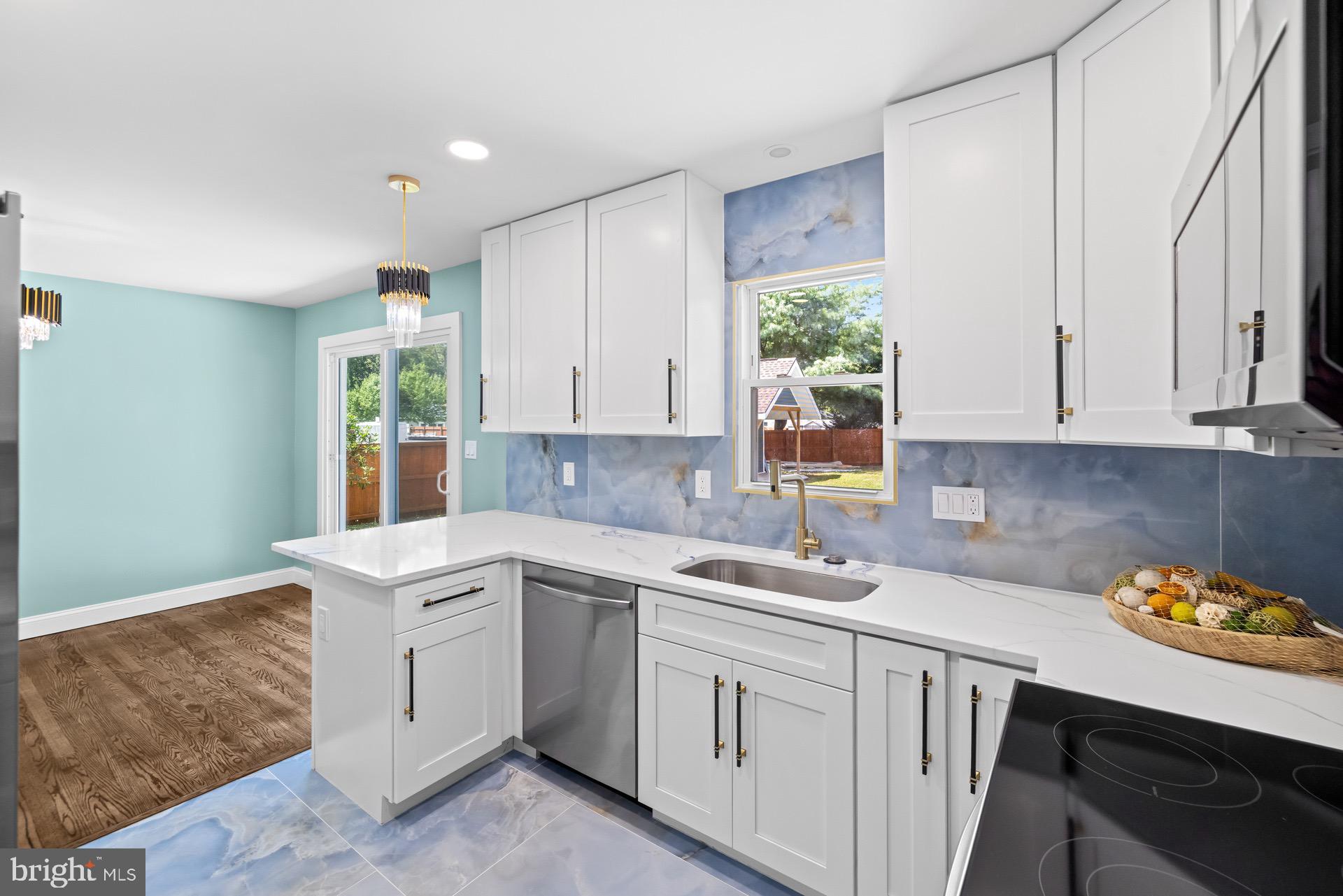 523 Sunset Knoll Road Pasadena, MD 21122 - Photo 14 of 60 a kitchen with a sink cabinets and window