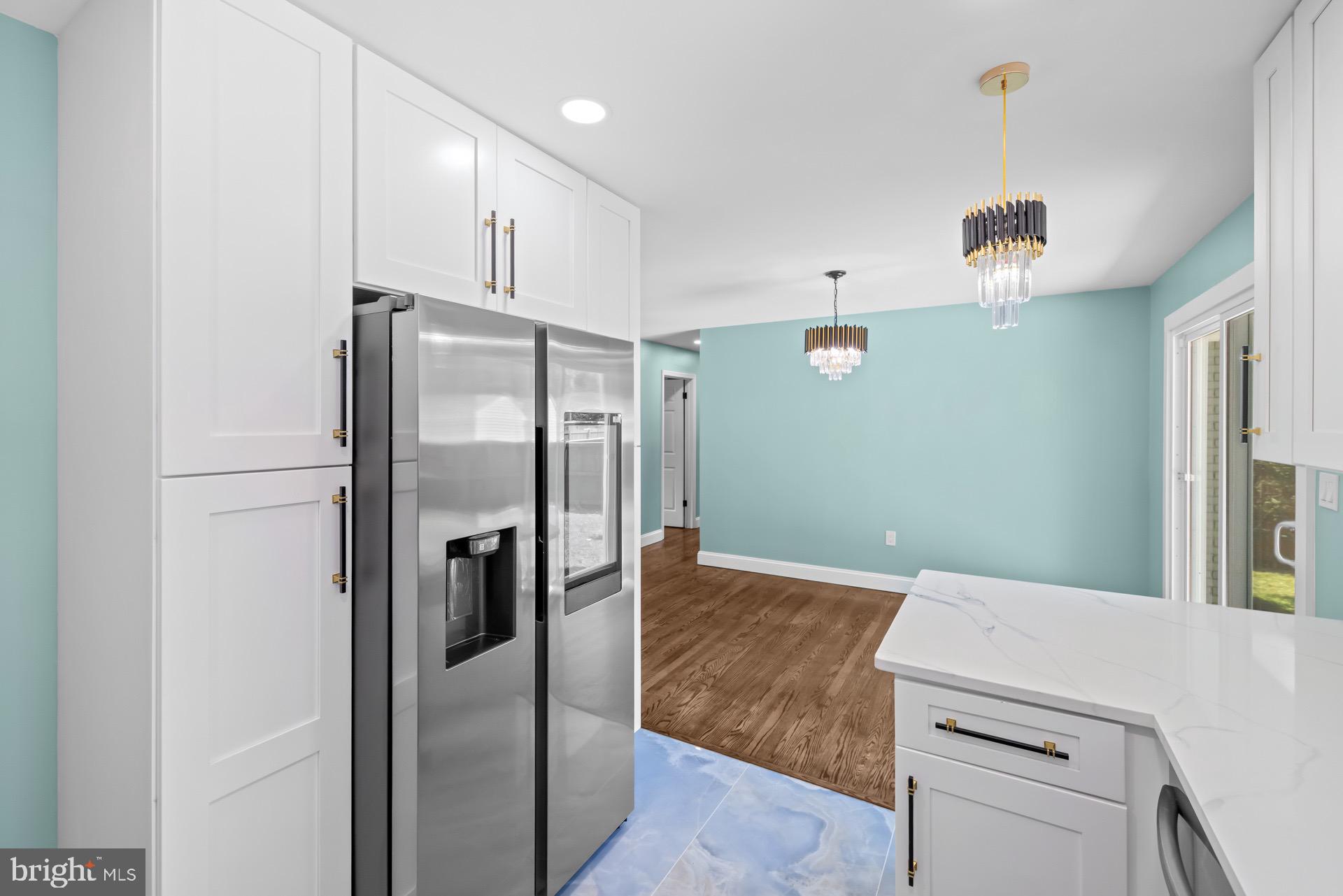 523 Sunset Knoll Road Pasadena, MD 21122 - Photo 15 of 60 a kitchen with a refrigerator and cabinets