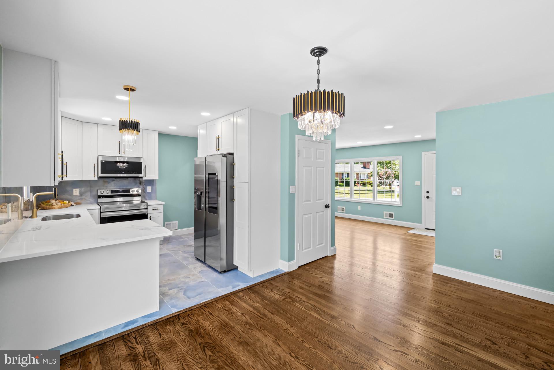 523 Sunset Knoll Road Pasadena, MD 21122 - Photo 16 of 60 a view of a kitchen with a refrigerator a microwave and a sink