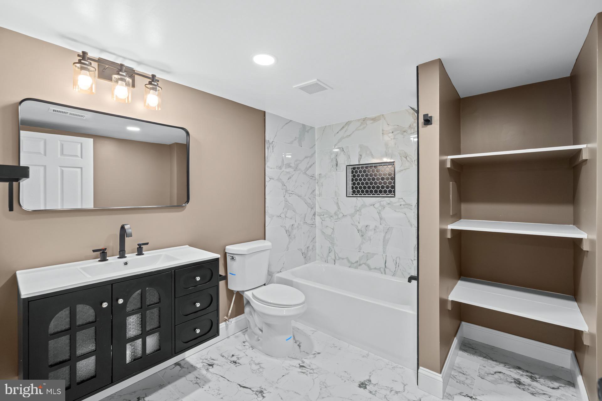 523 Sunset Knoll Road Pasadena, MD 21122 - Photo 46 of 60 a spacious bathroom with a toilet sink double vanity and bathtub