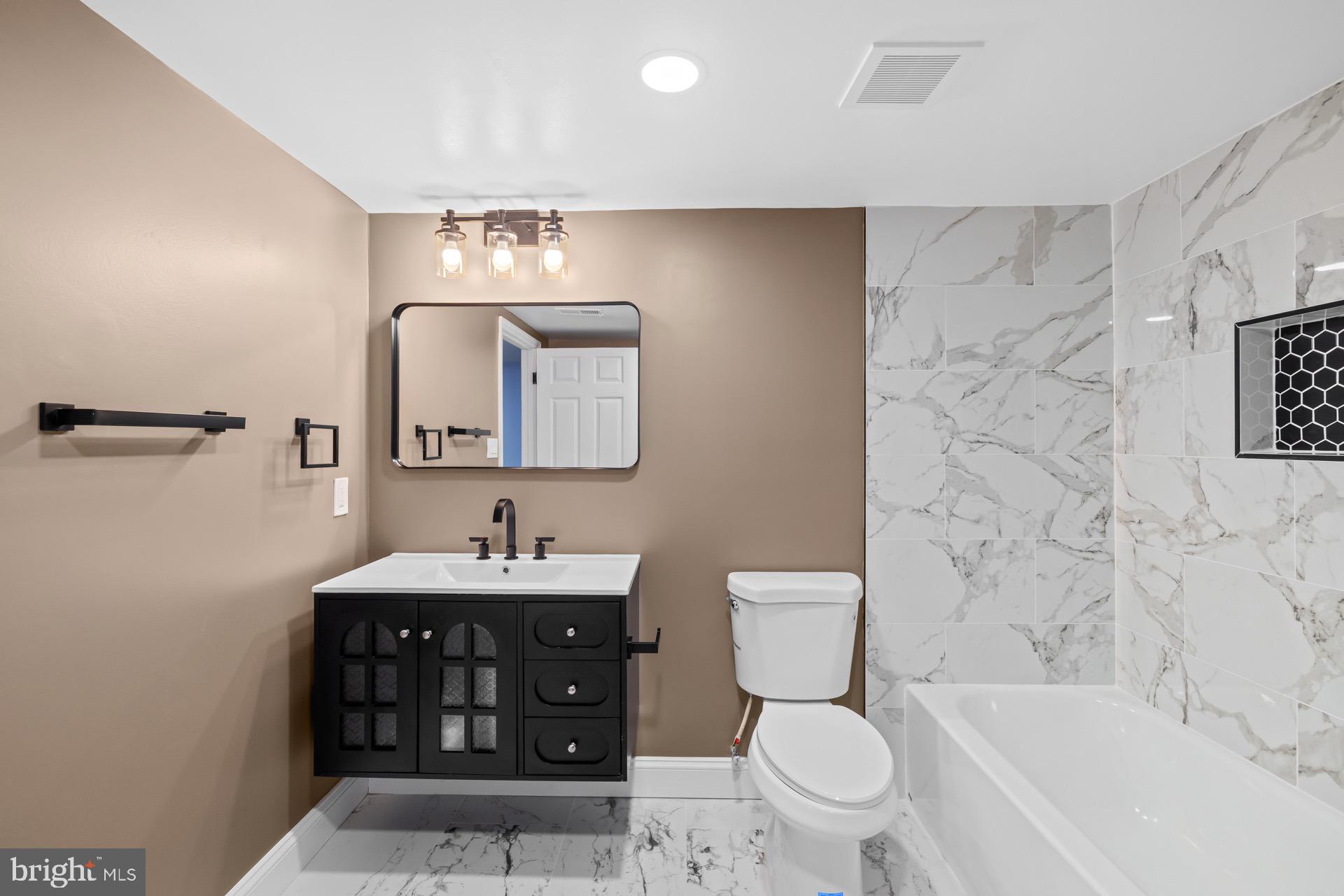 523 Sunset Knoll Road Pasadena, MD 21122 - Photo 47 of 60 a bathroom with a sink a toilet and shower