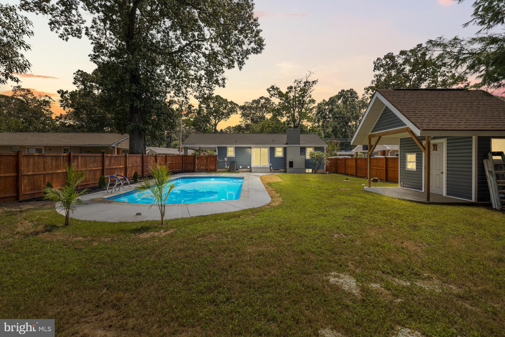 523 Sunset Knoll Road Pasadena, MD 21122 - Photo 55 of 60 a view of a house with a yard porch and sitting area