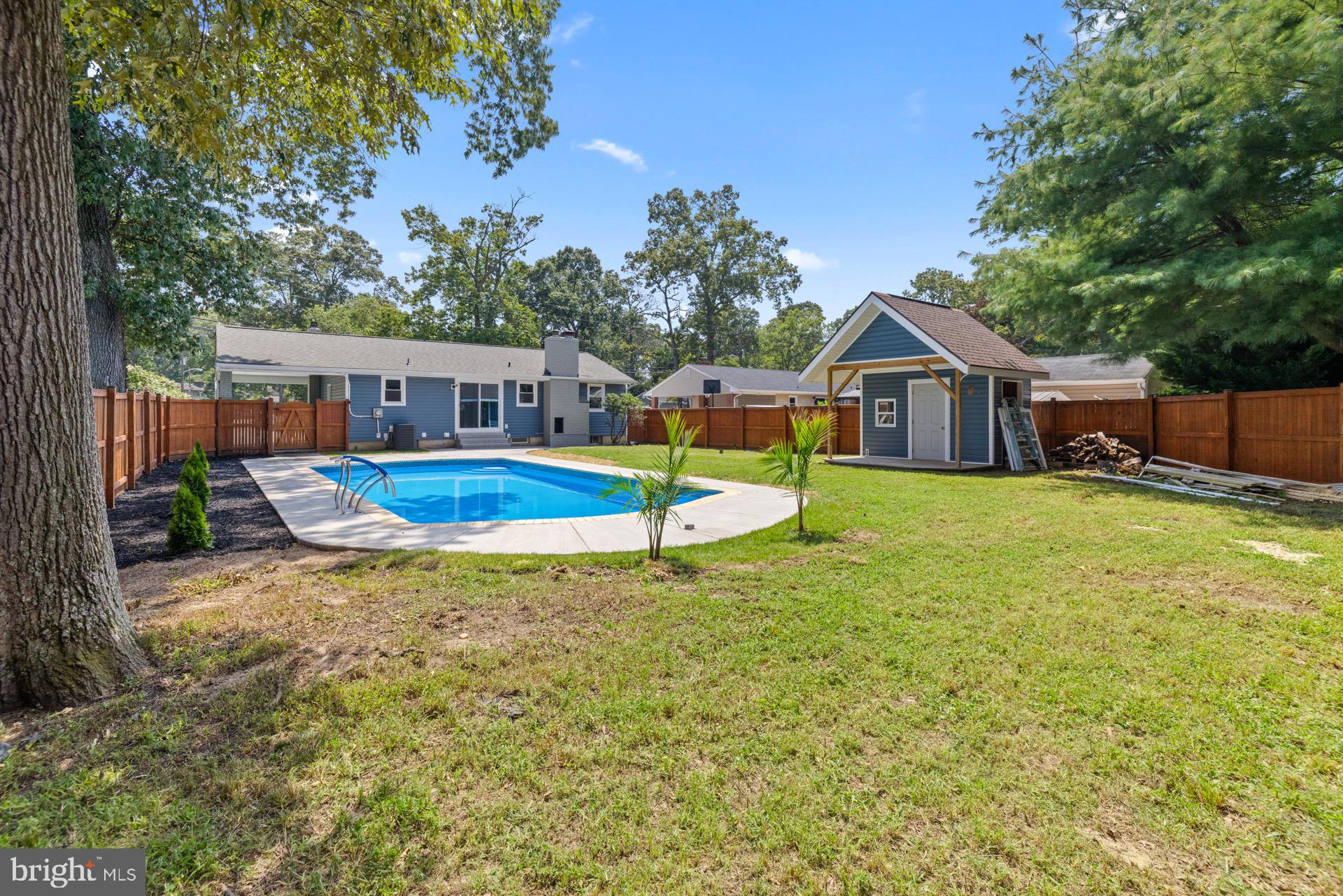 523 Sunset Knoll Road Pasadena, MD 21122 - Photo 57 of 60 a view of a house with a yard patio and swimming pool