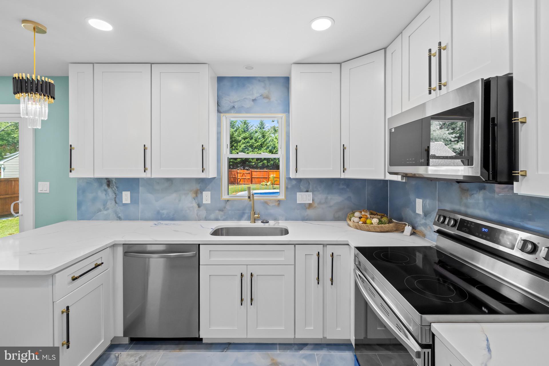 523 Sunset Knoll Road Pasadena, MD 21122 - Photo 9 of 60 a kitchen with stainless steel appliances granite countertop a sink stove refrigerator and cabinets
